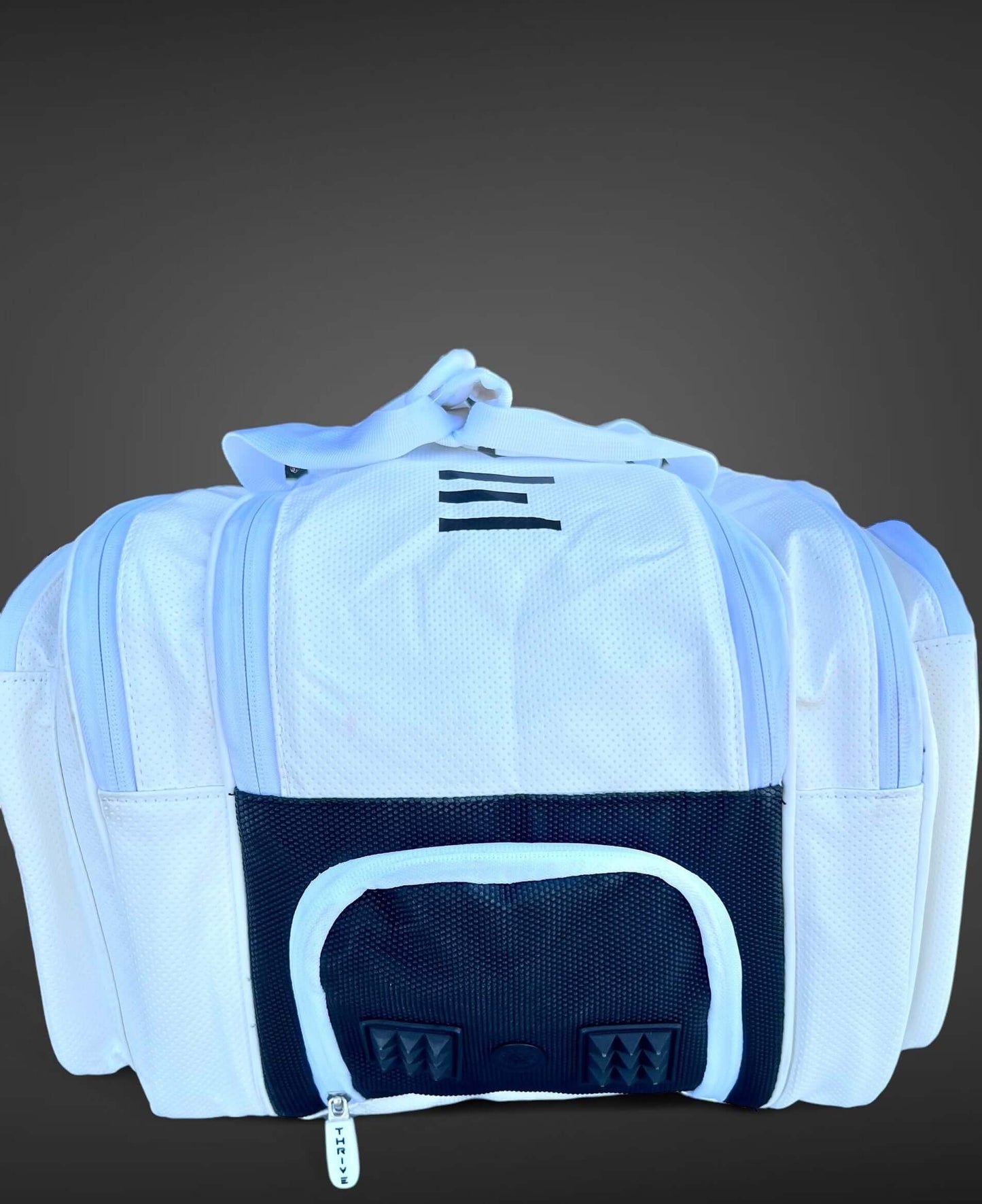 Thrive new Elite Pro Tour Bag in white is made of 100% vegan leather and designed for the player who wants to look good and travel to the courts in style. This bag has room for all your paddles and accessories and doubles as carry-on luggage. The backpack
