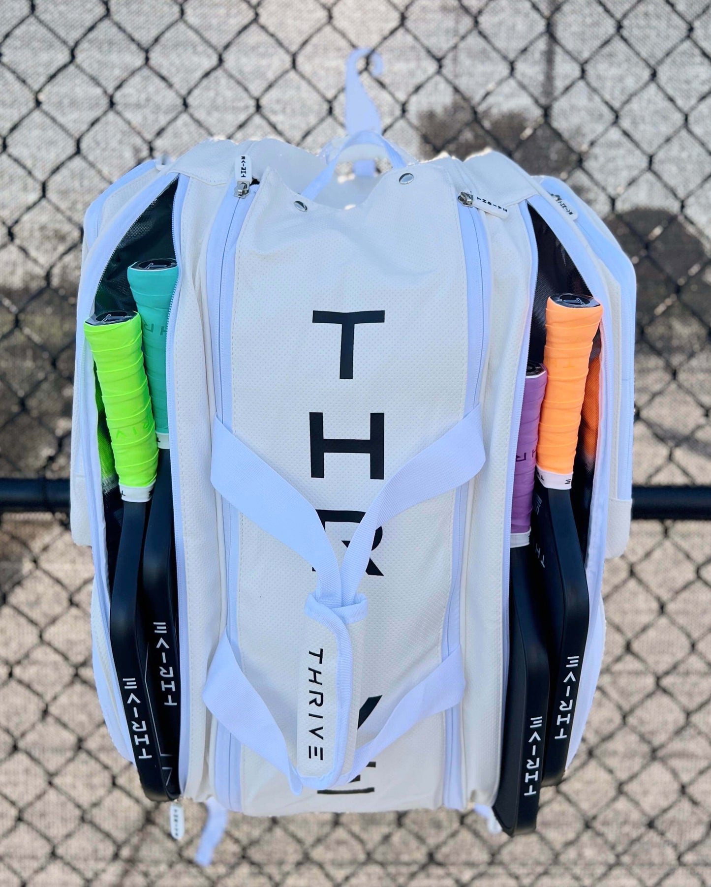 Thrive new Elite Pro Tour Bag in white is made of 100% vegan leather and designed for the player who wants to look good and travel to the courts in style. This bag has room for all your paddles and accessories and doubles as carry-on luggage. The backpack