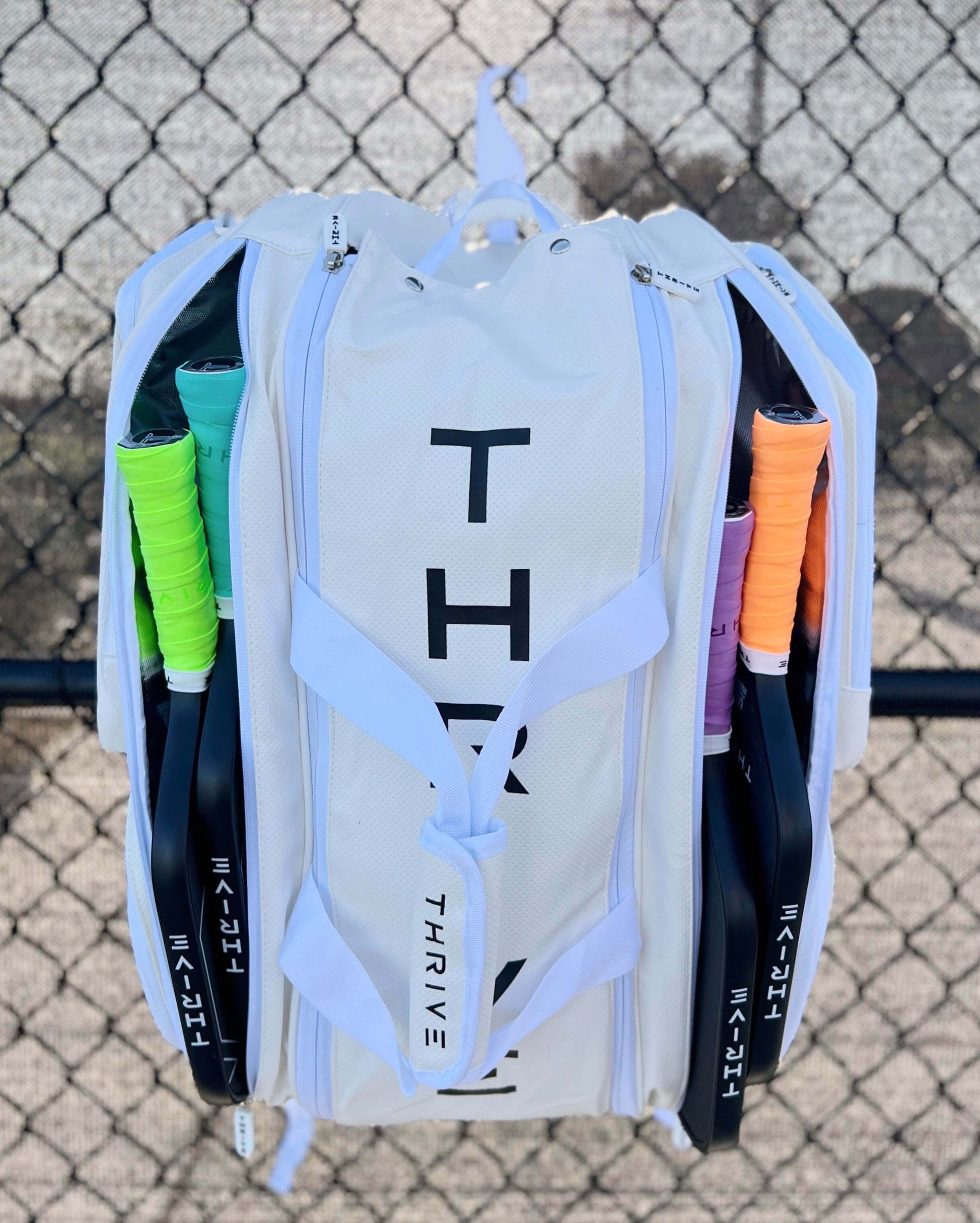 Thrive new Elite Pro Tour Bag in white is made of 100% vegan leather and designed for the player who wants to look good and travel to the courts in style. This bag has room for all your paddles and accessories and doubles as carry-on luggage. The backpack