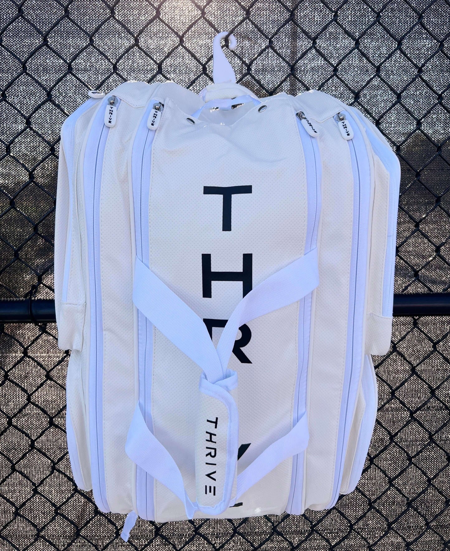 Thrive new Elite Pro Tour Bag in white is made of 100% vegan leather and designed for the player who wants to look good and travel to the courts in style. This bag has room for all your paddles and accessories and doubles as carry-on luggage. The backpack