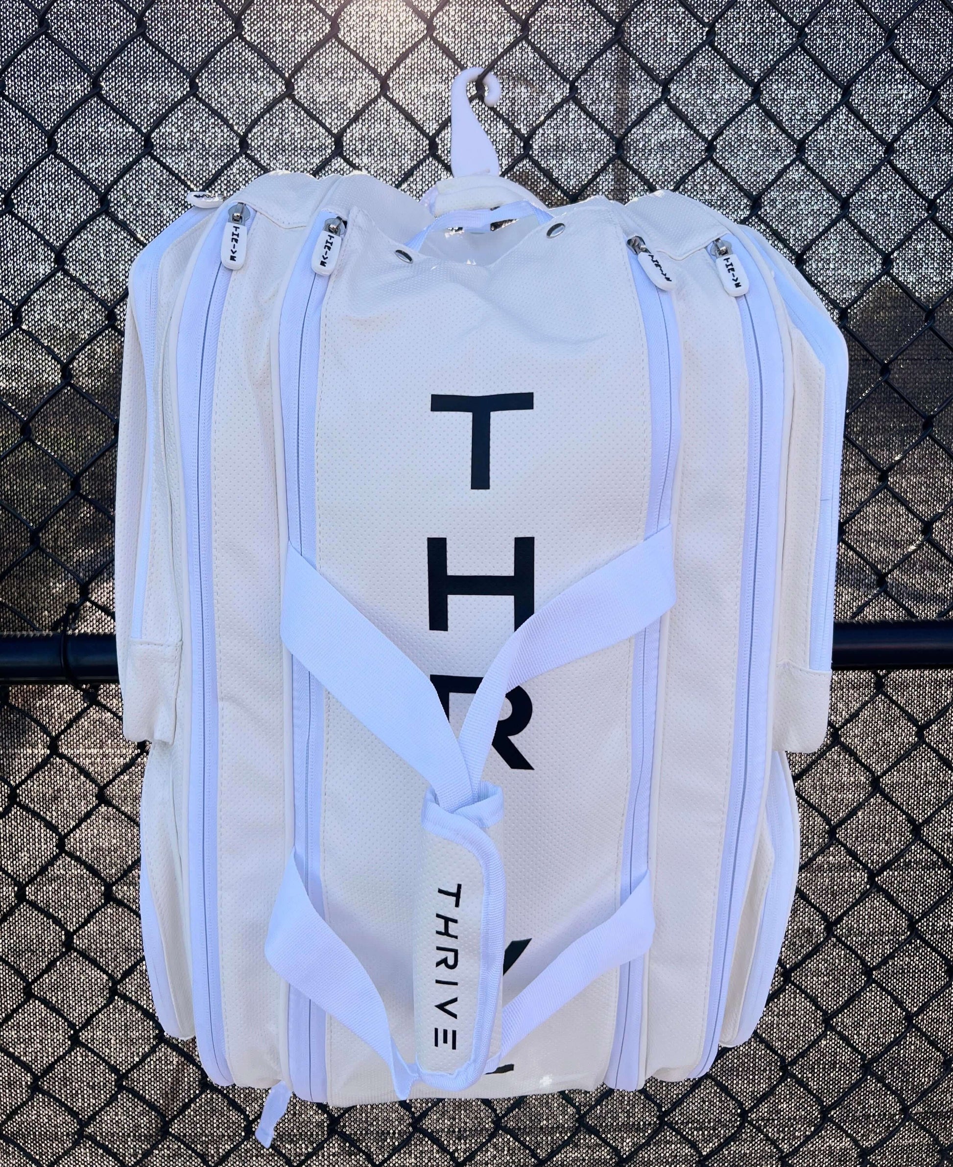 Thrive new Elite Pro Tour Bag in white is made of 100% vegan leather and designed for the player who wants to look good and travel to the courts in style. This bag has room for all your paddles and accessories and doubles as carry-on luggage. The backpack