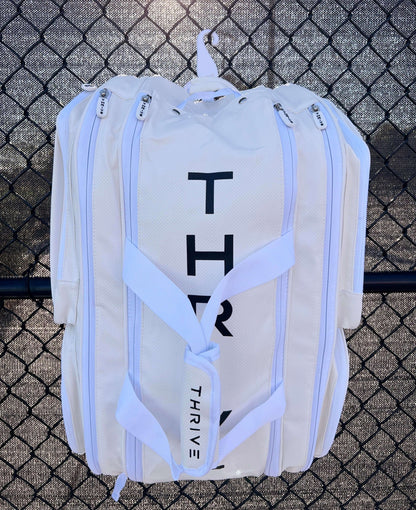Thrive new Elite Pro Tour Bag in white is made of 100% vegan leather and designed for the player who wants to look good and travel to the courts in style. This bag has room for all your paddles and accessories and doubles as carry-on luggage. The backpack