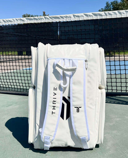 Thrive new Elite Pro Tour Bag in white is made of 100% vegan leather and designed for the player who wants to look good and travel to the courts in style. This bag has room for all your paddles and accessories and doubles as carry-on luggage. The backpack