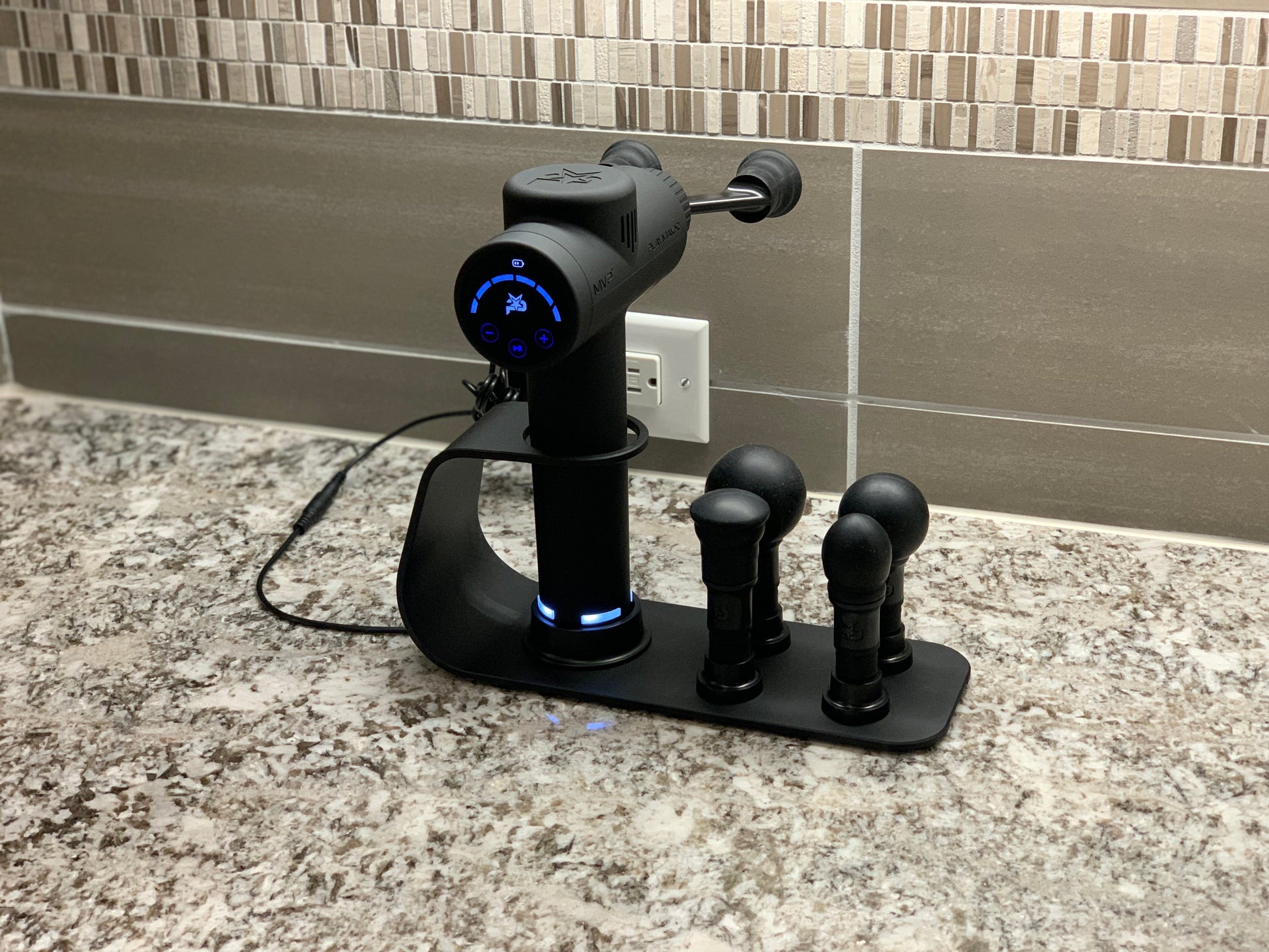 Introducing the ultimate 2-in-1 charging station – the perfect companion for your MVP-2000 Percussion Massager. With premium technology, it swiftly charges your massage gun while providing convenient access to your device and ProTips™. Say goodbye to clut