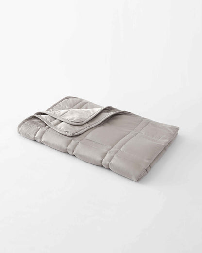 The gentle benefits of a weighted blanket in a compact size! Place it on your lap for better focus while working, on-the-go comfort traveling, or across your body after yoga for a next level savasana. Optional cover has a simple sham closure and connectiv