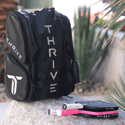 Thrive Elite Pro Tour Bag is made of 100% vegan leather and designed for the player who wants to look good and travel to the courts in style. This bag has room for all your paddles and accessories and doubles as carry-on luggage. The backpack straps have